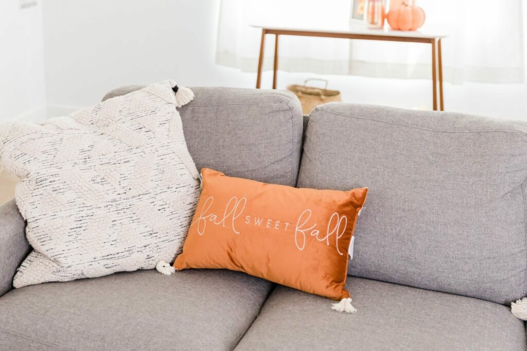 Cushion on sofa that reads Fall Sweet Fall